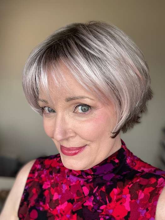short silver wig for women styled as a layered bob with soft bangs on smiling model