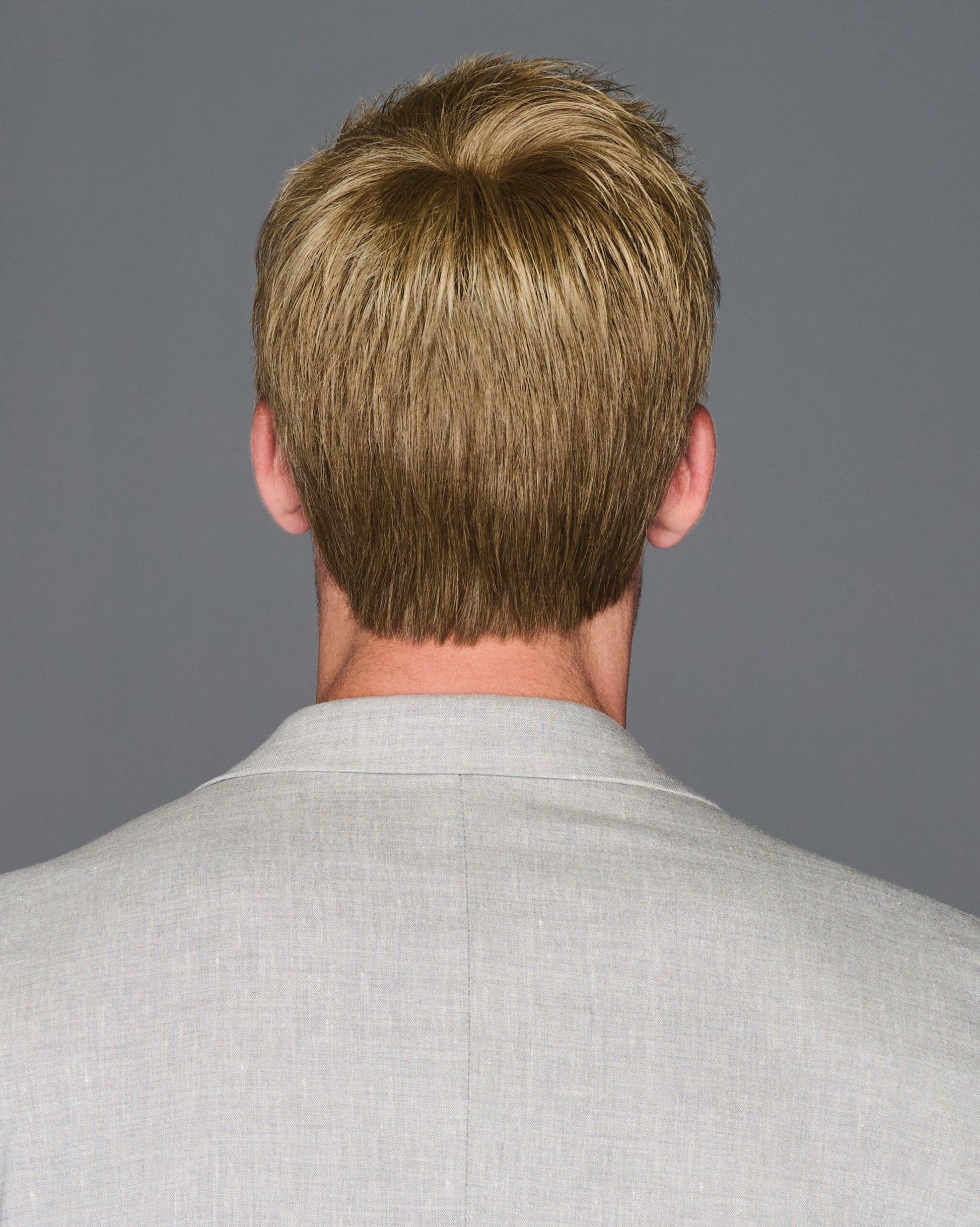 Back view of man wearing HairUWear Dapper HIM wig for men light brown short tapered nape haircut