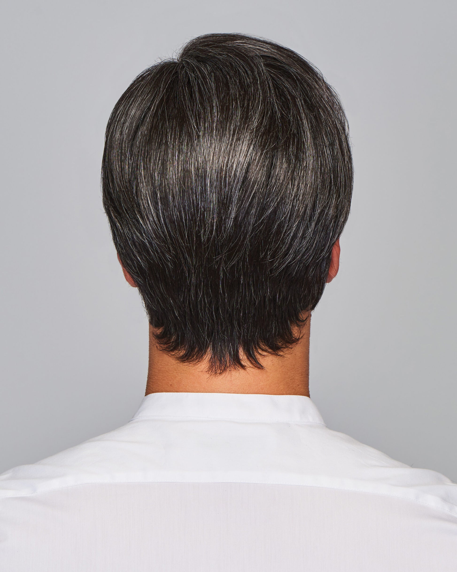 Back view of salt and pepper short layered HairUWear Gallant HIM wig for men showing natural texture and neckline