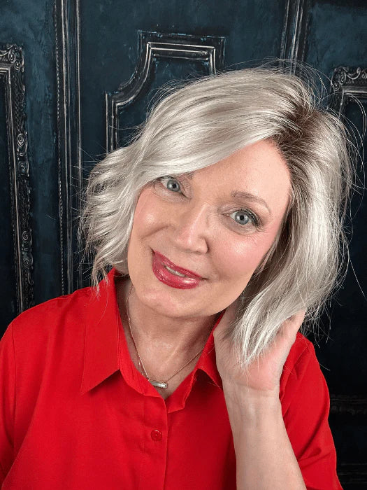 short silver blonde wig for women modeled by smiling woman in red blouse shoulder length asymmetrical bob