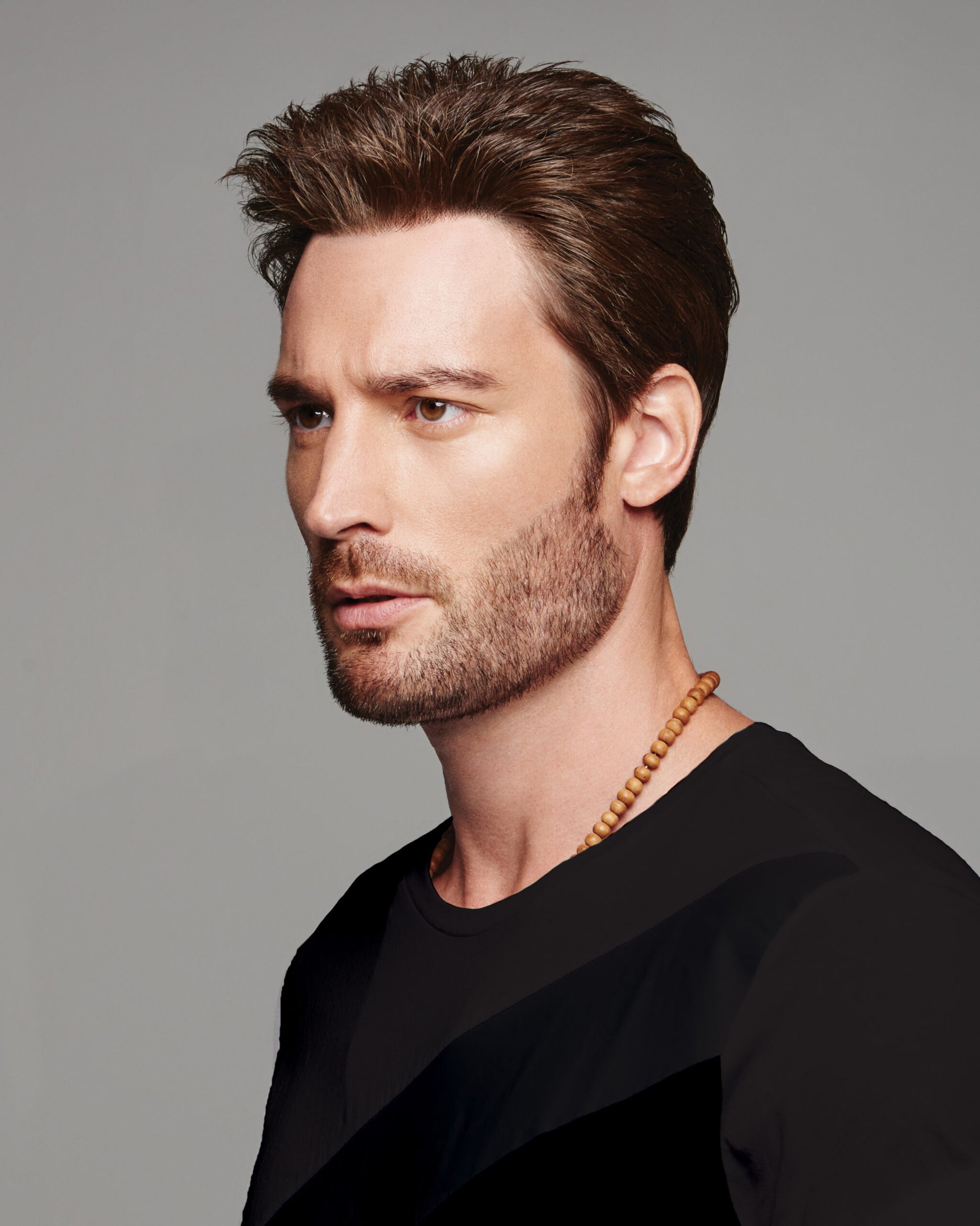 HairUWear men's natural look wig in dark brown styled short textured cut on a bearded male model