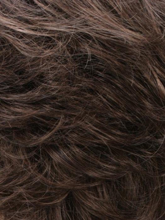 Close-up of a human hair wiglet for thinning hair featuring soft, wavy strands in dark brown shades