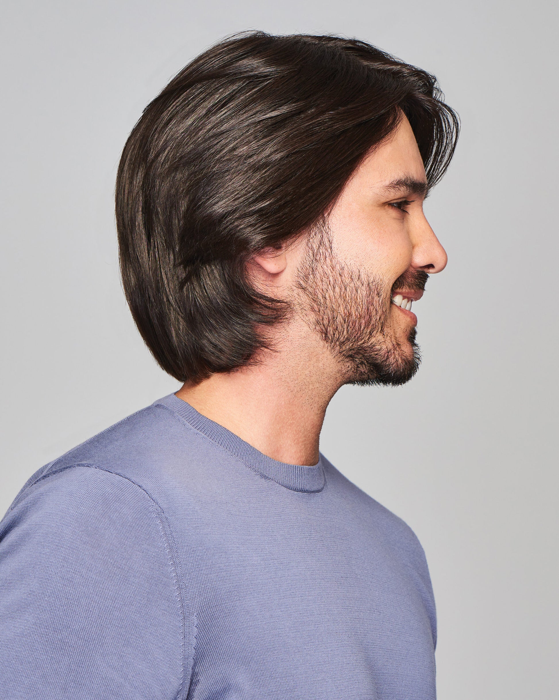 Sharp HIM wig for men styled in dark brown medium length with layered sides and natural hairline on model