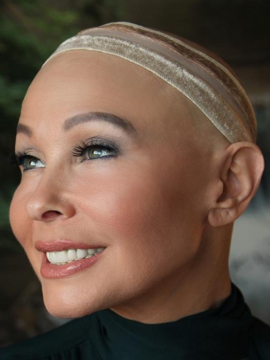 Close-up of a woman wearing a skin-toned cap demonstrating a reversible wig grip for sensitive scalp