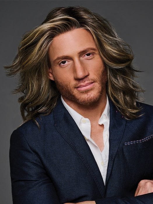HairUWear Admirable HIM wig for men. man wearing long layered wavy brown wig with blonde highlights and natural hairline