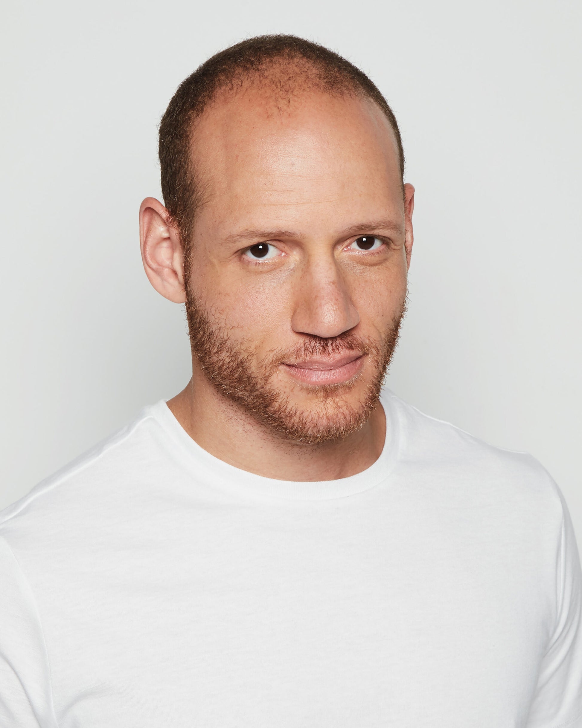 Male model in white tee modeling Admirable HIM wig for men natural brown hairline and stubble